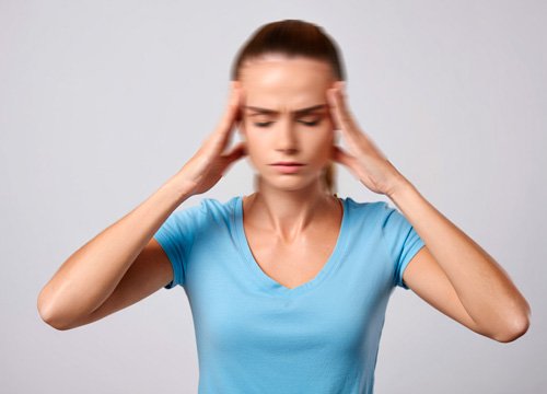 Головокружение Девушка держится за голову